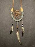 Handmade horseshoe dreamcatcher with orange web, black beads and natural feathers