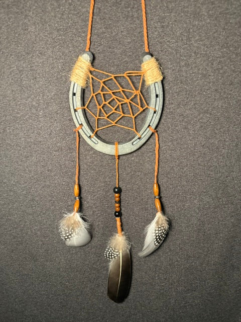 Handmade horseshoe dreamcatcher with orange web, black beads and natural feathers