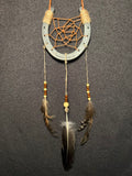 Handmade horseshoe dreamcatcher with orange web, wood beads and brown natural feathers