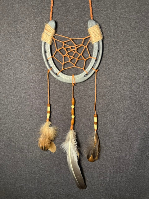 Handmade horseshoe dreamcatcher with orange web, wood beads and natural feathers