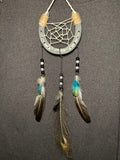 Handmade horseshoe dreamcatcher with white web, turquoise accents and peacock feather