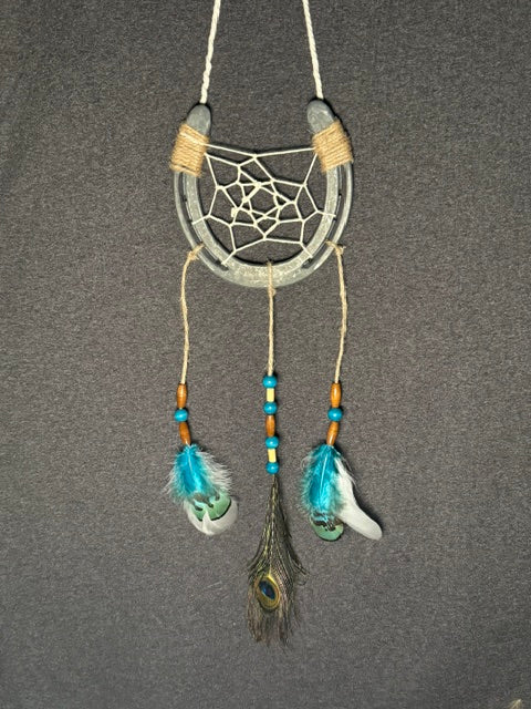 Handmade horseshoe dreamcatcher with white web, turquoise beads and feathers